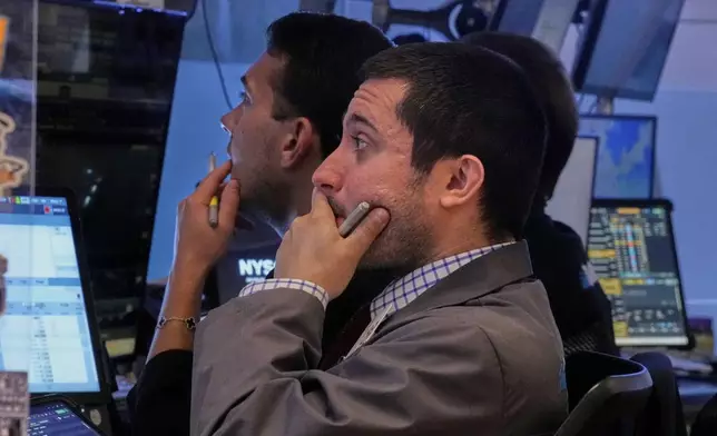 Trader Drew Cohen, foreground, works with colleagues on the floor of the New York Stock Exchange, Friday, Sept. 5, 2025. (AP Photo/Richard Drew)