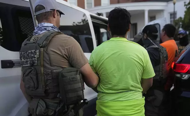 U.S. Immigration and Customs Enforcement agents make an arrest during an early morning operation in Park Ridge, Ill., Friday, Sept. 19, 2025. (AP Photo/Erin Hooley)