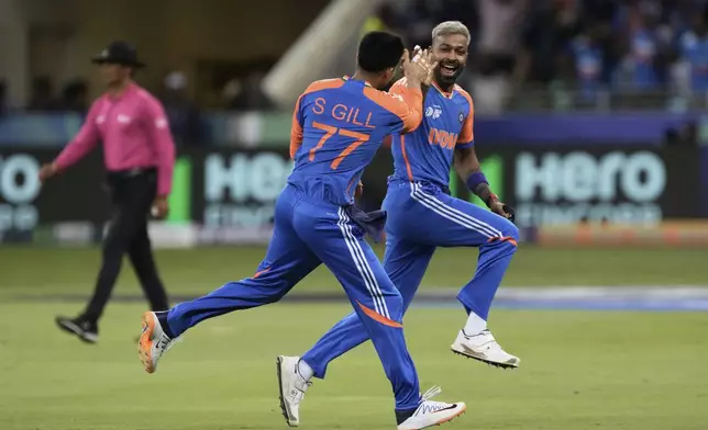 India's Hardik Pandya, right, celebrates with teammate Shubman Gill after the dismissal of Pakistan's Saim Ayub during the Asia Cup cricket match between India and Pakistan at Dubai International Cricket Stadium in Dubai, United Arab Emirates, Sunday, Sept. 14, 2025. (AP Photo/Fatima Shbair)
