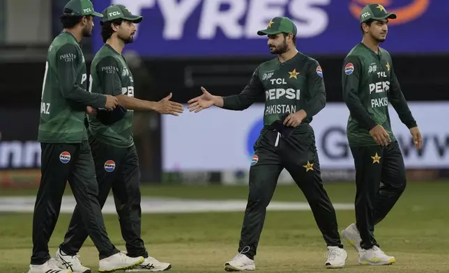 Pakistan players greet each other after their loss in the Asia Cup cricket match against India at Dubai International Cricket Stadium in Dubai, United Arab Emirates, Sunday, Sept. 14, 2025. (AP Photo/Fatima Shbair)