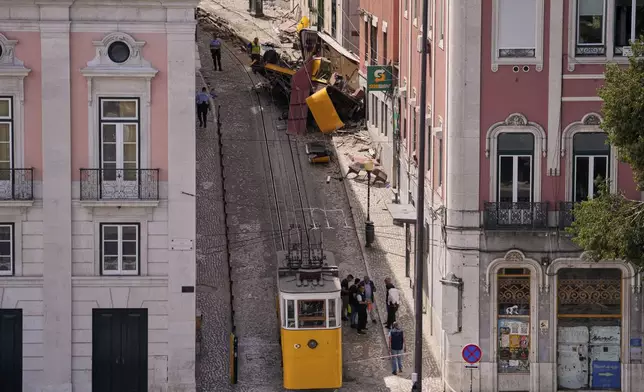 Police officers inspect the site where a tourist streetcar derailed and crashed in Lisbon, Portugal, Thursday, Sept. 4, 2025. (AP Photo/Armando Franca)