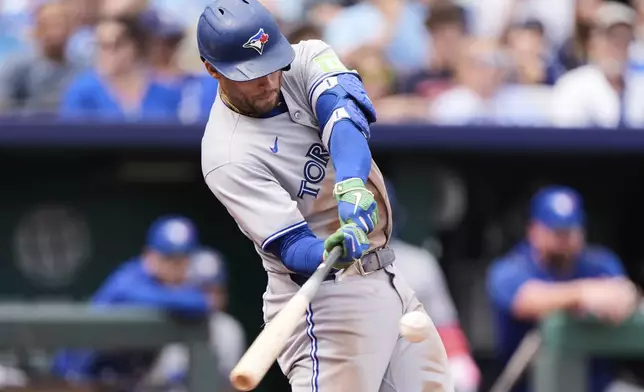 Toronto Blue Jays' George Springer hits an RBI double during the second inning of a baseball game against the Kansas City Royals, Sunday, Sept. 21, 2025, in Kansas City, Mo. (AP Photo/Charlie Riedel)