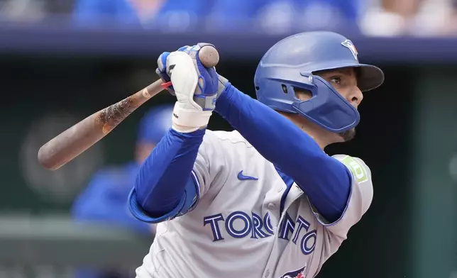 Toronto Blue Jays' Andres Gimenez watches his RBI single during the second inning of a baseball game against the Kansas City Royals, Sunday, Sept. 21, 2025, in Kansas City, Mo. (AP Photo/Charlie Riedel)