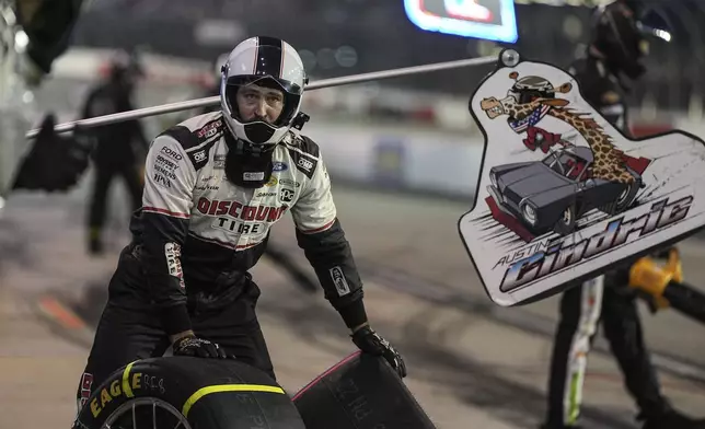 A pit crew member for Austin Cindric prepares for a pit stop during a NASCAR Cup Series auto race at Darlington Raceway, Sunday, Aug. 31, 2025, in Darlington, S.C. (AP Photo/Matt Kelley)