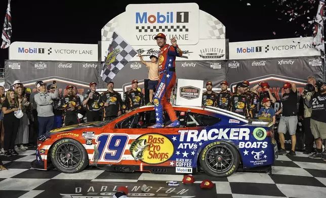 Chase Briscoe, center, celebrates with his son Brooks in Victory Lane after winning a NASCAR Cup Series auto race at Darlington Raceway, Sunday, Aug. 31, 2025, in Darlington, S.C. (AP Photo/Matt Kelley)