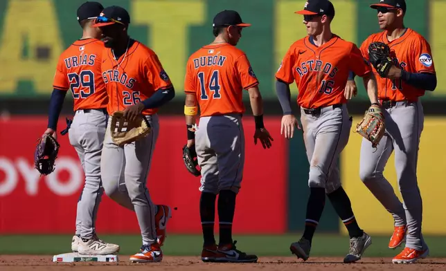 The Houston Astros celebrate their win over the Athletics in a baseball game Thursday, Sept. 25, 2025, in West Sacramento, Calif. (AP Photo/Scott Marshall)