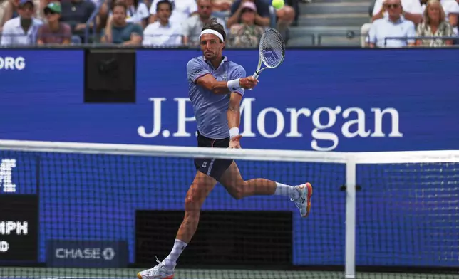 Arthur Rinderknech, of France, returns a shot against Carlos Alcaraz, of Spain, during the fourth round of the U.S. Open tennis championships, Sunday, Aug. 31, 2025, in New York. (AP Photo/Heather Khalifa)