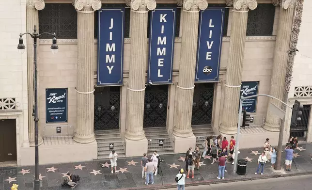 Pedestrians and media gather in front of the Jimmy Kimmel Live studio on Hollywood Blvd., Wednesday, Sept. 17, 2025, in Los Angeles. (AP Photo/Chris Pizzello)