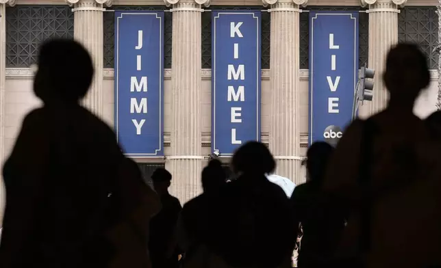 People walk by the Jimmy Kimmel Live studio on Hollywood Blvd., Wednesday, Sept. 17, 2025, in Los Angeles. (AP Photo/Chris Pizzello)