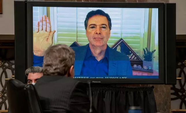 FILE - Former FBI director James Comey is sworn via videoconference before testifying during a Senate Judiciary Committee hearing on Capitol Hill in Washington, Wednesday, Sept. 30, 2020, to examine the FBI "Crossfire Hurricane" investigation. (Ken Cedeno/Pool via AP, File)