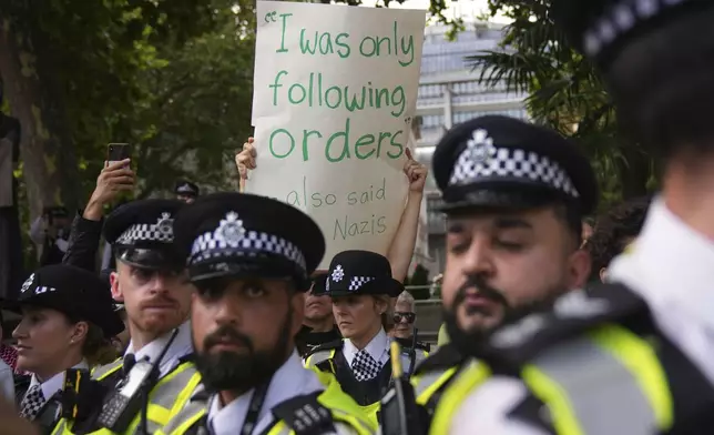Police officers block a protest to support Palestine Action in London, Saturday, Sept. 6, 2025.(AP Photo/Joanna Chan)