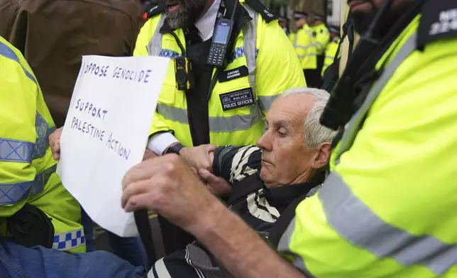 Police officers carry a protester during a protest to support Palestine Action in London, Saturday, Sept. 6, 2025.(AP Photo/Joanna Chan)
