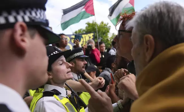 Protesters argue with police officers during a protest to support Palestine Action in London, Saturday, Sept. 6, 2025.(AP Photo/Joanna Chan)