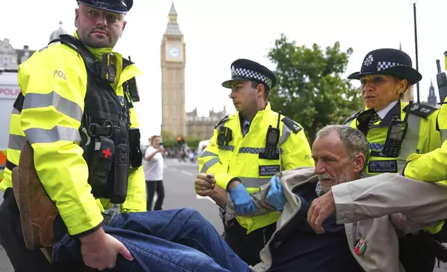 Police officers carry a protester during a protest to support Palestine Action in London, Saturday, Sept. 6, 2025.(AP Photo/Joanna Chan)