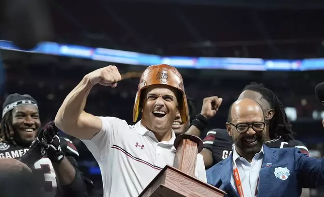 South Carolina head coach Shane Beamer celebrates after an NCAA college football game against Virginia Tech, Sunday, Aug. 31, 2025, in Atlanta. (AP Photo/Brynn Anderson)