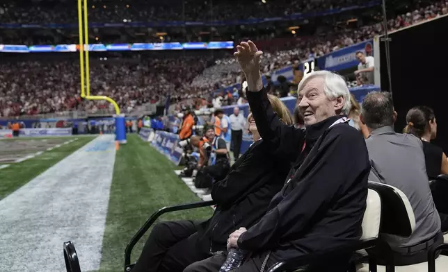 Former Virginia Tech coach Frank Beamer waves to the crowd before an NCAA college football game against South Carolina, Sunday, Aug. 31, 2025, in Atlanta. (AP Photo/Brynn Anderson)
