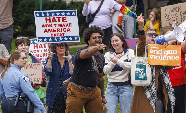 Protesters gather to demonstrate against gun violence in Minneapolis, Wednesday, Sept. 3, 2025, as Vice President JD Vance visits the city a week after a deadly school shooting at Annunciation Catholic Church. (Kerem Yücel/Minnesota Public Radio via AP)