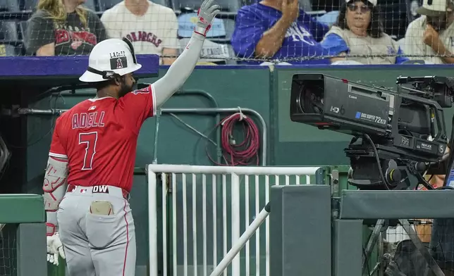 Los Angeles Angels' Jo Adell celebrates for a television camera after hitting a three-run home run during the sixth inning of a baseball game against the Kansas City Royals, Wednesday, Sept. 3, 2025, in Kansas City, Mo. (AP Photo/Charlie Riedel)