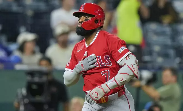 Los Angeles Angels' Jo Adell celebrates as he crosses the plate after hitting a three-run home run during the sixth inning of a baseball game against the Kansas City Royals, Wednesday, Sept. 3, 2025, in Kansas City, Mo. (AP Photo/Charlie Riedel)