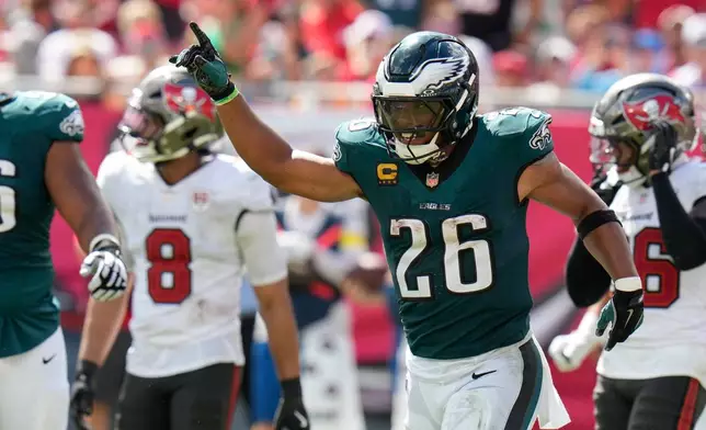 Philadelphia Eagles running back Saquon Barkley (26) celebrates after scoring a touchdown during the second half of an NFL football game against the Tampa Bay Buccaneers, Sunday, Sept. 28, 2025, in Tampa, Fla. (AP Photo/Chris O'Meara)