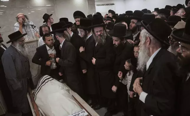 Mourners attend the funeral of Levi Yitzhak Pash, who was killed along with five other Israelis in a shooting attack by two Palestinian gunmen at a bus stop in Jerusalem Monday, Sept. 8, 2025. (AP Photo/Ariel Schalit)