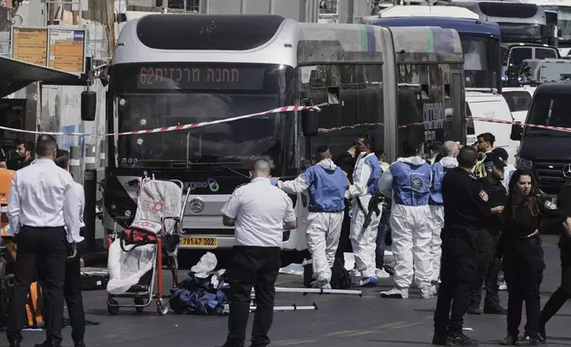 Israeli police and rescue teams respond at the scene of a shooting attack where several people killed and injured in Jerusalem, Monday, Sept. 8, 2025. (AP Photo/Mahmoud Illean)