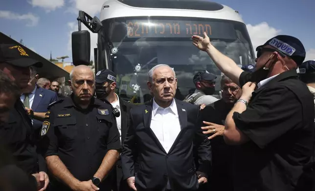 Israel's Prime Minister Benjamin Netanyahu visits the site of a shooting attack at a bus stop in Jerusalem, Monday, Sept. 8, 2025. (Ronen Zvulun/Pool Photo via AP)