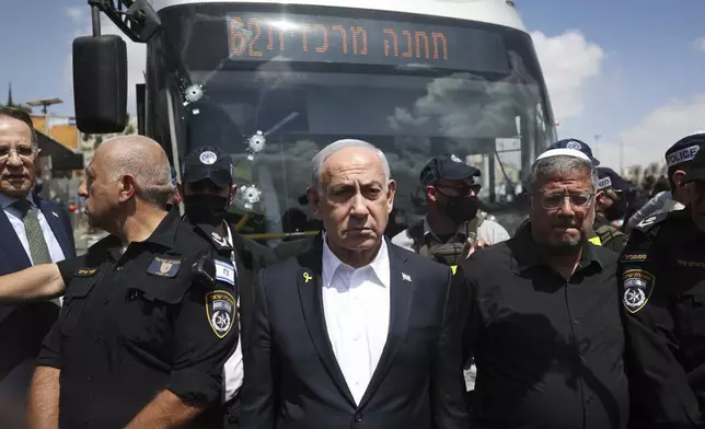 Israel's Prime Minister Benjamin Netanyahu and National Security Minister Itamar Ben-Gvir, right, visit the site of a shooting attack at a bus stop in Jerusalem, Monday, Sept. 8, 2025. (Ronen Zvulun/Pool Photo via AP)