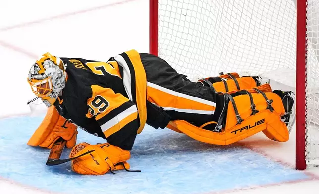 Pittsburgh Penguins goalie Marc-Andre Fleury does pushups in the goal crease between shooters during a shootout following a pre-season NHL hockey game against the Columbus Blue Jackets in Pittsburgh, Saturday, Sept. 27, 2025. (AP Photo/Gene J. Puskar)