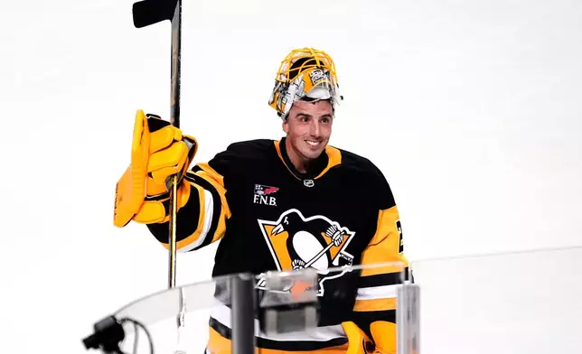 Pittsburgh Penguins goalie Marc-Andre Fleury acknowledges fans after being named the number one star in a pre-season NHL hockey game against the Columbus Blue Jackets in Pittsburgh, Saturday, Sept. 27, 2025. (AP Photo/Gene J. Puskar)