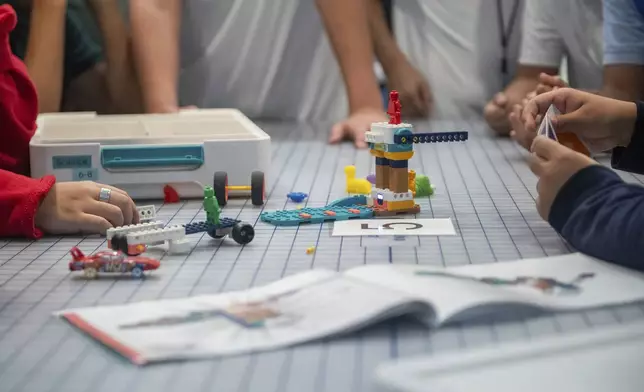 Students work on a project during a LEGO Education science lesson at Lorenzo De Zavala Middle School on Thursday, Aug. 21, 2025, in Irving, Texas. (AP Photo/Ronaldo Bolaños)