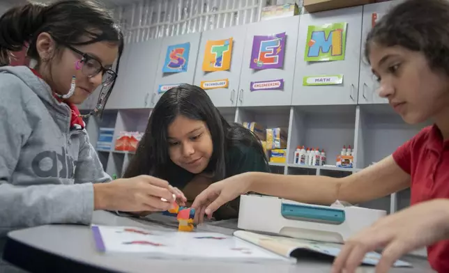 Students build a dragon out of LEGO bricks during class at Lively Elementary on Thursday, Aug. 21, 2025, in Irving, Texas. (AP Photo/Ronaldo Bolaños)