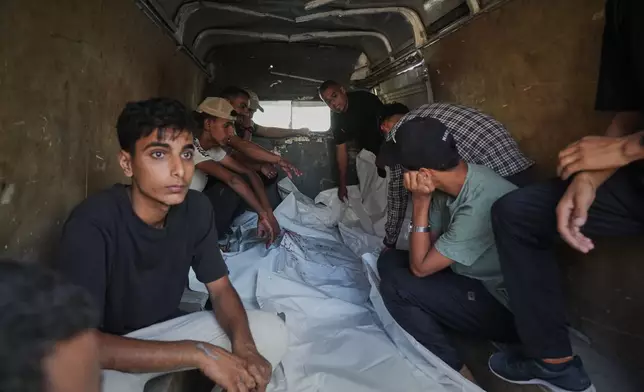 Mourners attend the funeral of Palestinians killed in an Israeli army strike, outside Al-Aqsa Hospital in Deir al-Balah, central Gaza Strip, Thursday, Sept. 25, 2025. (AP Photo/Abdel Kareem Hana)