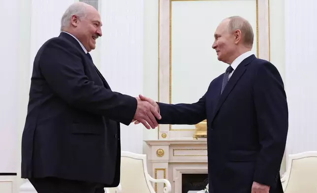 Russian President Vladimir Putin, right, and Belarusian President Alexander Lukashenko shake hands during their meeting a the Kremlin in Moscow, Russia, Friday, Sept. 26, 2025. (Ramil Sitdikov/Pool Photo via AP)