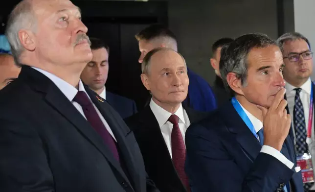 From left, Belarusian President Alexander Lukashenko, Russian President Vladimir Putin and International Atomic Energy Agency (IAEA) Director General Rafael Grossi visit the Atom pavilion at the Exhibition of Achievements of National Economy (VDNKh) ahead of the World Atomic Week forum in Moscow, Russia, Thursday, Sept. 25, 2025. (Alexei Nikolsky, Sputnik, Kremlin Pool Photo via AP)
