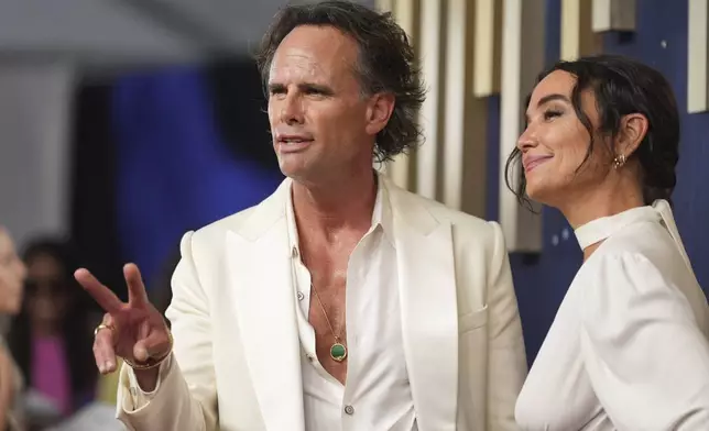 Walton Goggins, left, and Nadia Conners arrive at the 77th Primetime Emmy Awards on Sunday, Sept. 14, 2025, at the Peacock Theater in Los Angeles. (AP Photo/Jae C. Hong)