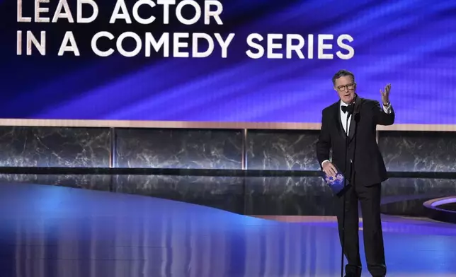 Stephen Colbert presents the award for outstanding lead actor in a comedy series during the 77th Primetime Emmy Awards on Sunday, Sept. 14, 2025, at the Peacock Theater in Los Angeles. (AP Photo/Chris Pizzello)