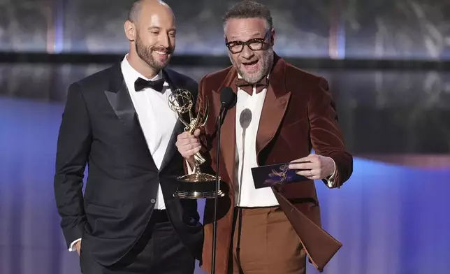 Evan Goldberg, left, and Seth Rogen accept the award for outstanding directing for a comedy series for "The Studio" during the 77th Primetime Emmy Awards on Sunday, Sept. 14, 2025, at the Peacock Theater in Los Angeles. (AP Photo/Chris Pizzello)
