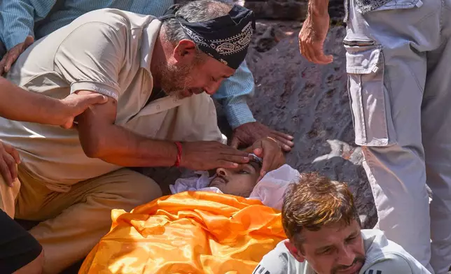 CORRECTS SPELLING OF NAME TO SHREEYAM, INSTEAD OF SHEEHAM - The father of Shreeyam Chaulagain, 19, who was killed during an anti-corruption protest that erupted after a social media ban, which has since been revoked, pays his last respects before his son's cremation at Pashupatinath, Kathmandu, Nepal, Friday, Sept. 12, 2025. (AP Photo/Niranjan Shrestha)