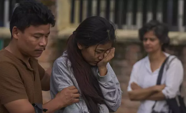 Relatives of a person killed during anti-corruption protests that erupted after a social media ban, later revoked, react at the postmortem block of the Teaching Hospital in Kathmandu, Nepal, Friday, Sept. 12, 2025. (AP Photo/Niranjan Shrestha)