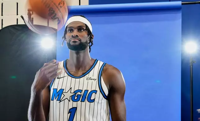 Orlando Magic forward Jonathan Isaac tosses a ball during the NBA basketball team's media day, Monday, Sept. 29, 2025, in Orlando, Fla. (AP Photo/John Raoux)