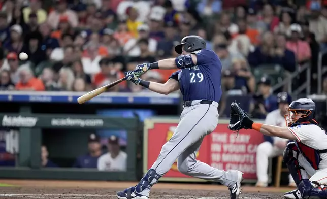 Seattle Mariners' Cal Raleigh (29) hits a solo home run, his 57th of the season, against the Houston Astros during the third inning of a baseball game Saturday, Sept. 20, 2025, in Houston. (AP Photo/Eric Christian Smith)
