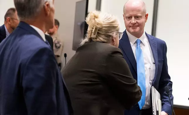 Utah County Attorney's Office prosecutor Chad Grunander, right, meets defense attorney Kathryn Nester, following a waiver hearing for Tyler Robinson, the man accused of killing Charlie Kirk at Utah Valley University, in Utah County Court in Provo, Utah, on Monday, Sept. 29, 2025. (Laura Seitz/The Deseret News via AP, Pool)
