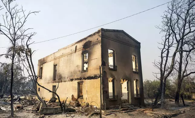 Exterior walls stand at a building destroyed by the TCU September Lightning Complex fire in the Chinese Camp community of Tuolumne County, Calif., on Wednesday, Sept. 3, 2025. (AP Photo/Noah Berger)
