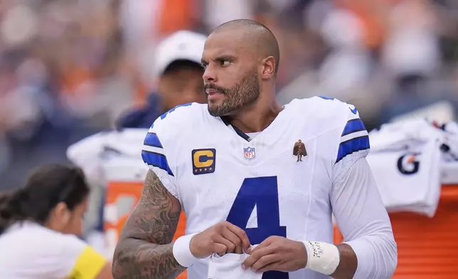 Dallas Cowboys quarterback Dak Prescott (4) stands on the sideline in the first half of an NFL football game against the Chicago Bears Sunday, Sept. 21, 2025, in Chicago. (AP Photo/Erin Hooley)