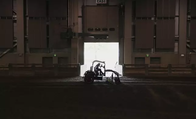 Ben Phillips test drives an electric tractor Tuesday, Aug. 19, 2025, during a demonstration in East Lansing, Mich. (AP Photo/Joshua A. Bickel)