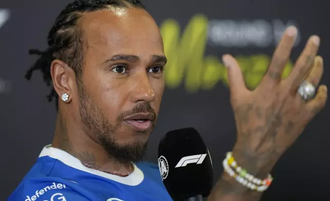 Ferrari driver Lewis Hamilton of Britain gestures during a news conference at the Monza racetrack, in Monza, Italy, Thursday, Sept. 4, 2025. (AP Photo/Luca Bruno)