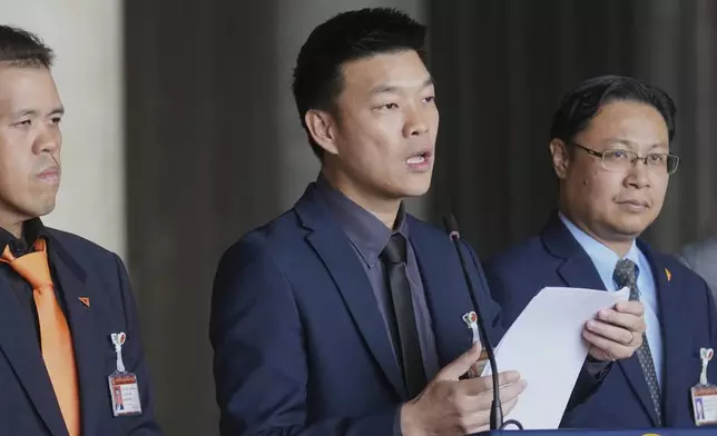 Leader of People's Party, Natthaphong Ruengpanyawut, center, talks to reporters during a press conference at Parliament in Bangkok, Thailand, Wednesday, Sept. 3, 2025. (AP Photo/Sakchai Lalit)