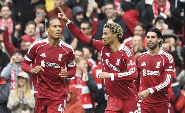 Liverpool's Hugo Ekitike, centre, celebrates after scoring his side's second goal during the English Premier League soccer match between Liverpool and Everton at Anfield stadium in Liverpool, England, Saturday, Sept. 20, 2025. (AP Photo/Rui Vieira)