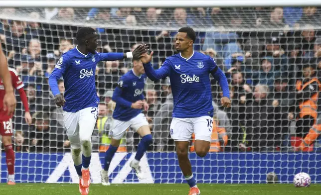 Everton's Idrissa Gueye, left, celebrates with Everton's Iliman Ndiaye after scoring his side's opening goal during the English Premier League soccer match between Liverpool and Everton at Anfield stadium in Liverpool, England, Saturday, Sept. 20, 2025. (AP Photo/Rui Vieira)